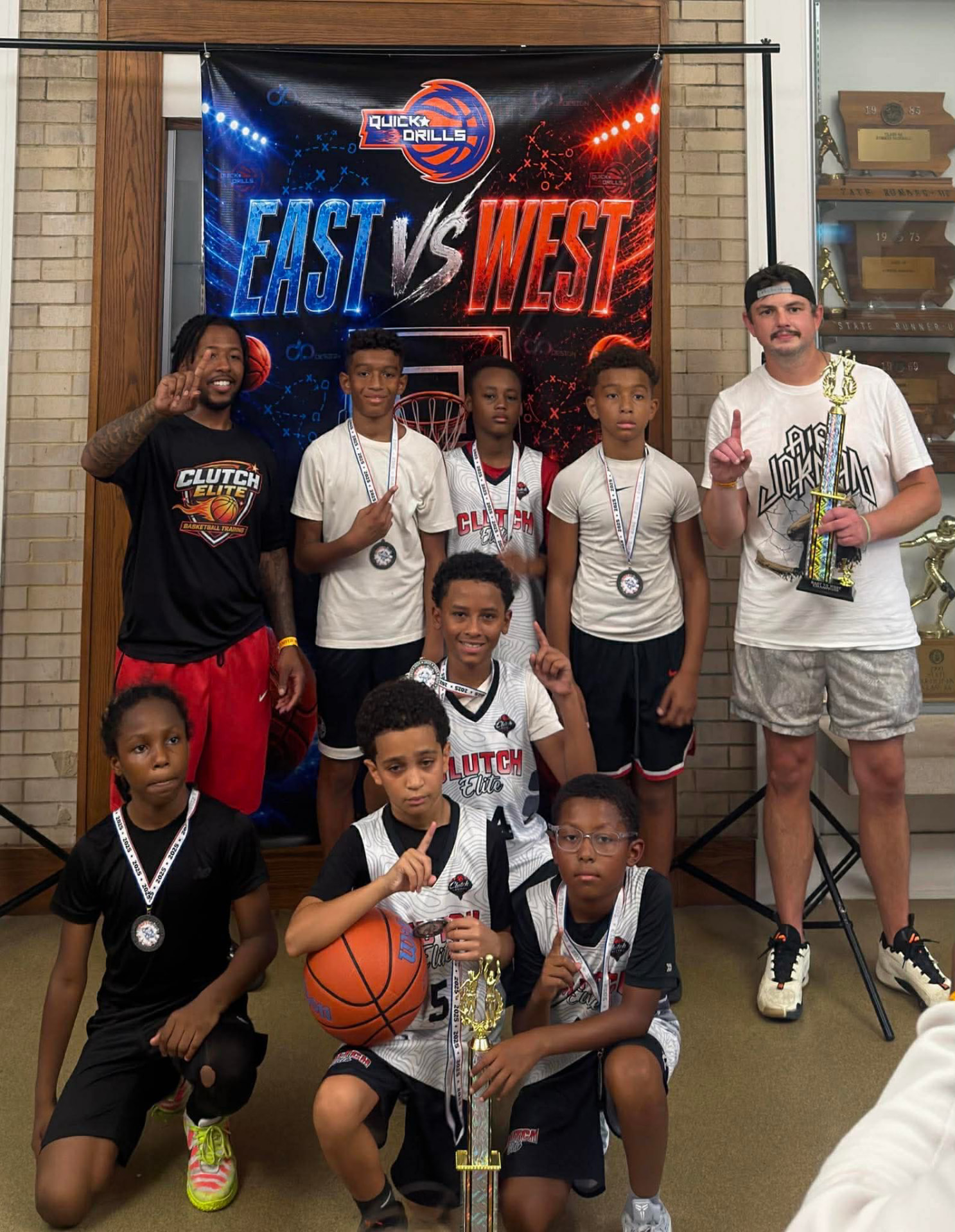Clutch Elite players holding a championship trophy